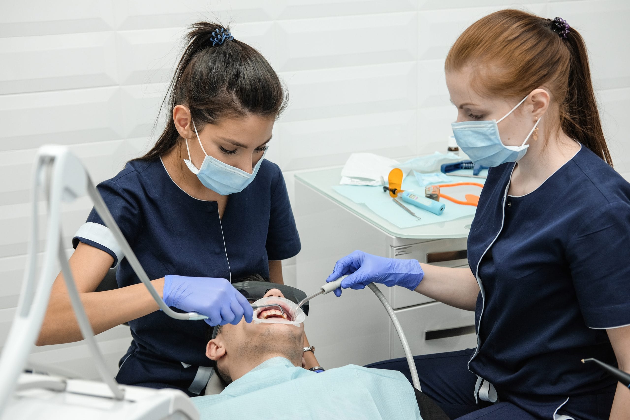 Dental nurse treats the patient. Doctor treats tooth pain at the dentist's office.